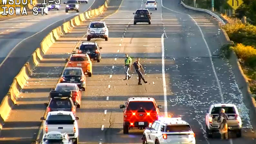 Crews work to clear Interstate 5 of soda cans following a spill Tuesday morning