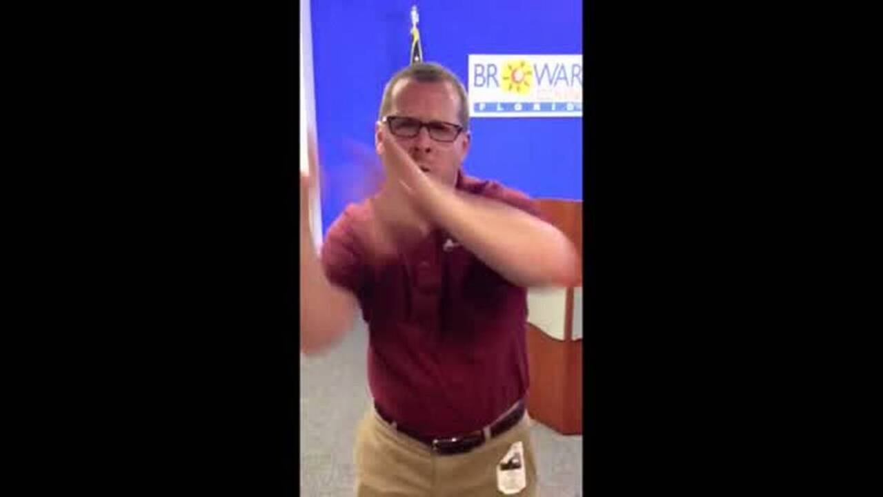 Sign language interpreter shows how to sign 'hurricane'