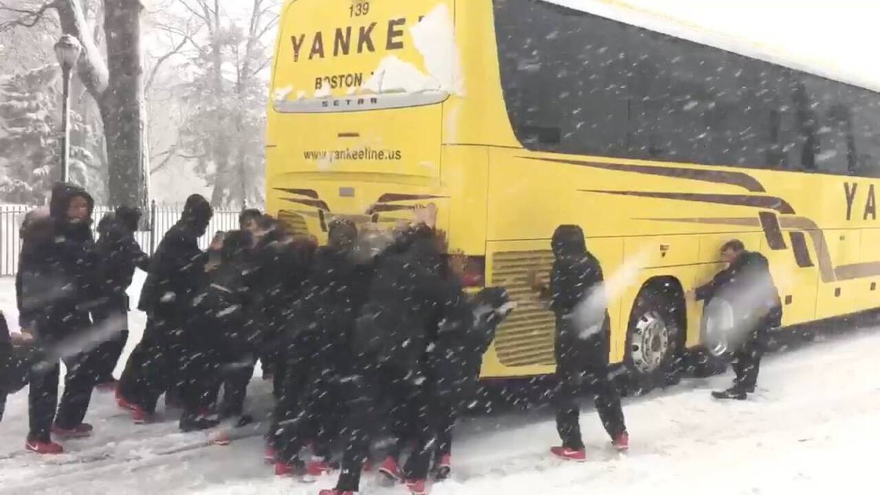Northeastern University basketball team pushes bus out of snow in Philadelphia during nor'easter