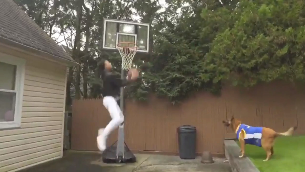 Man throws down windmill dunk with assist from a furry friend