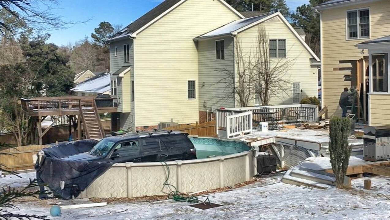 SUV crashes through garage and into pool