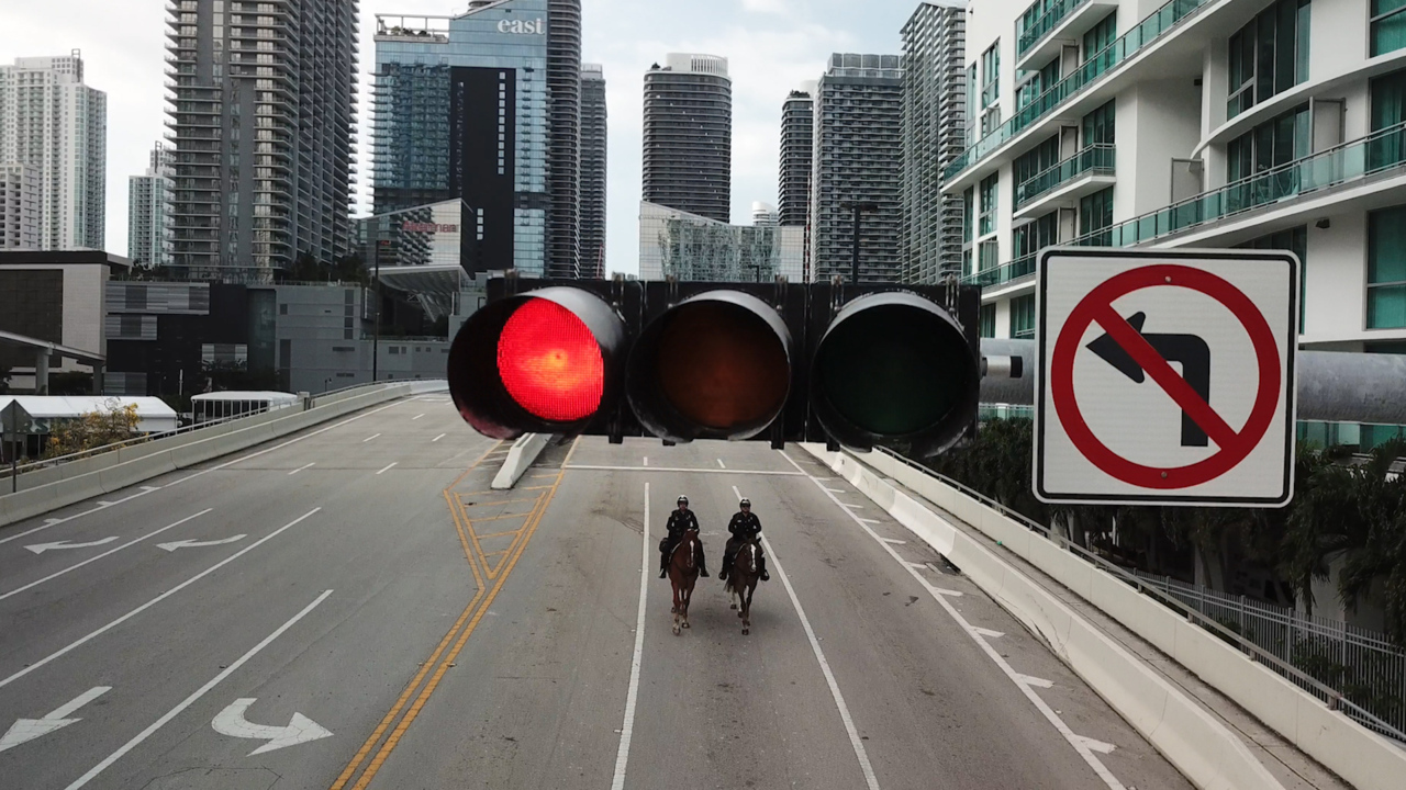 Miami police officers patrol an empty downtown on horseback during coronavirus pandemic