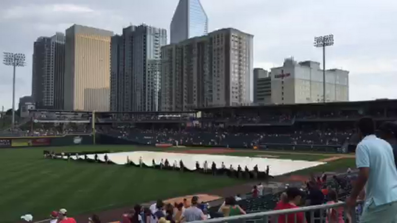 BB&T Ballpark's field is uncovered after rain delay