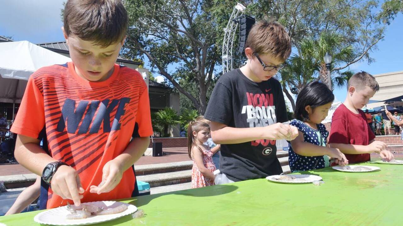 Children compete in shrimp peeling at the Beaufort Shrimp Festival