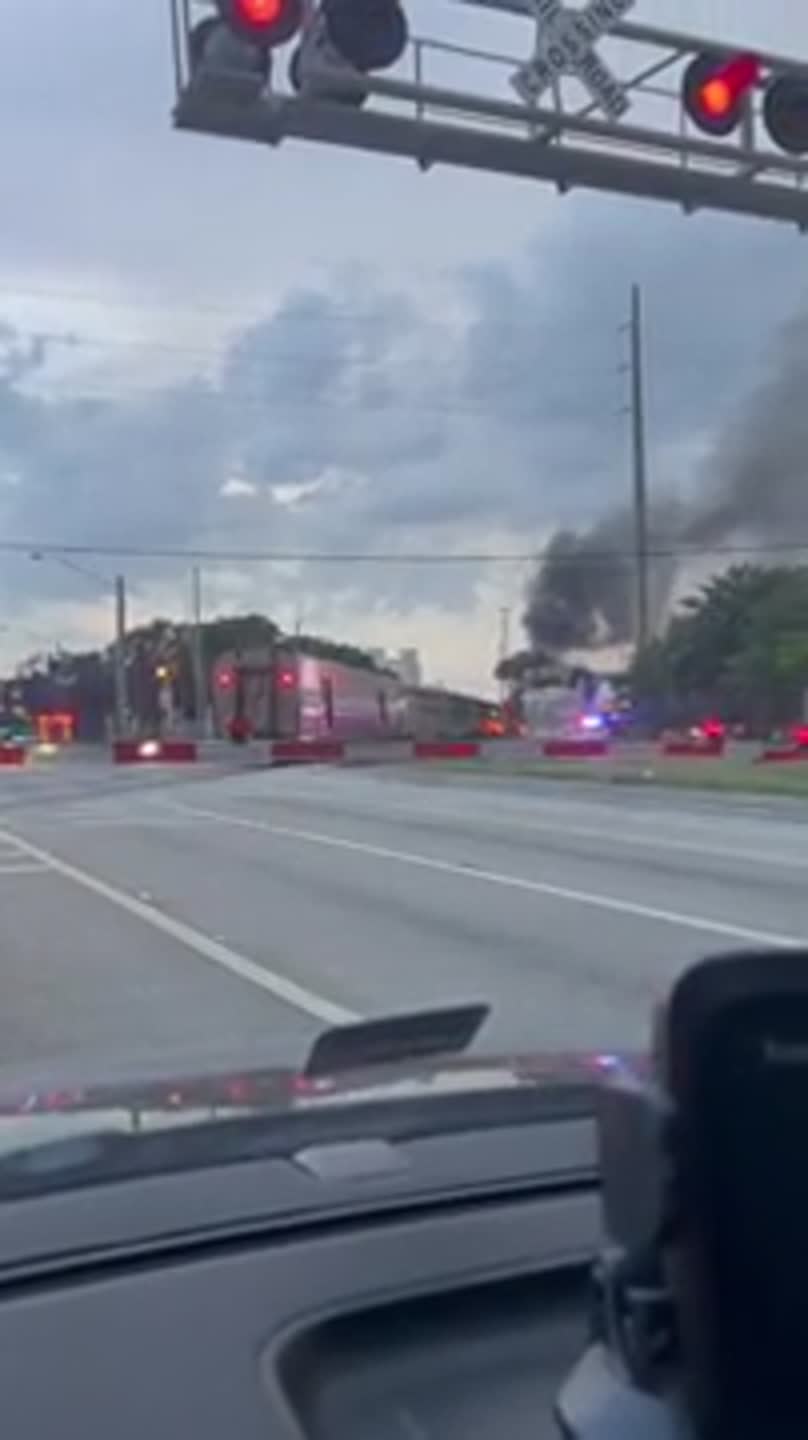 Fire is seen near a train in Oakland Park