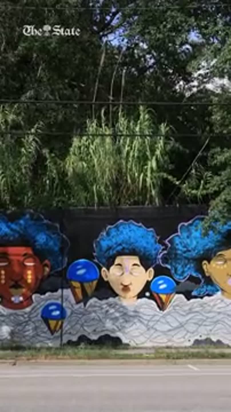What is up the staircases around the Millwood Mural?