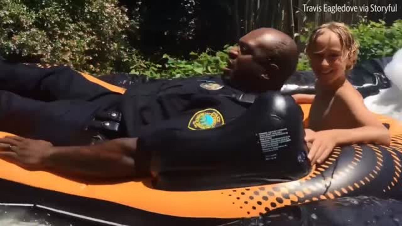 Watch a North Carolina police officer take the plunge on a slip-and-slide