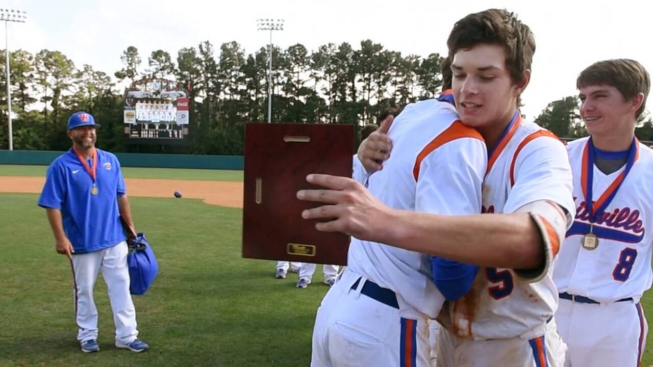 MacKenzie Gore, the NCHSAA 1A baseball championship MVP, gives his trophy to teammate