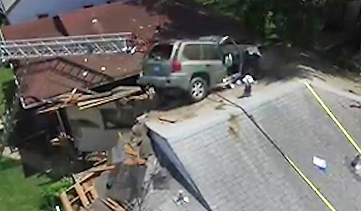 SUV lands on top of house in St. Louis