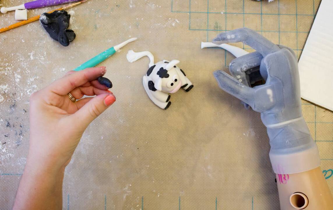 Cake decorator explains how she uses robotic prosthetic arm