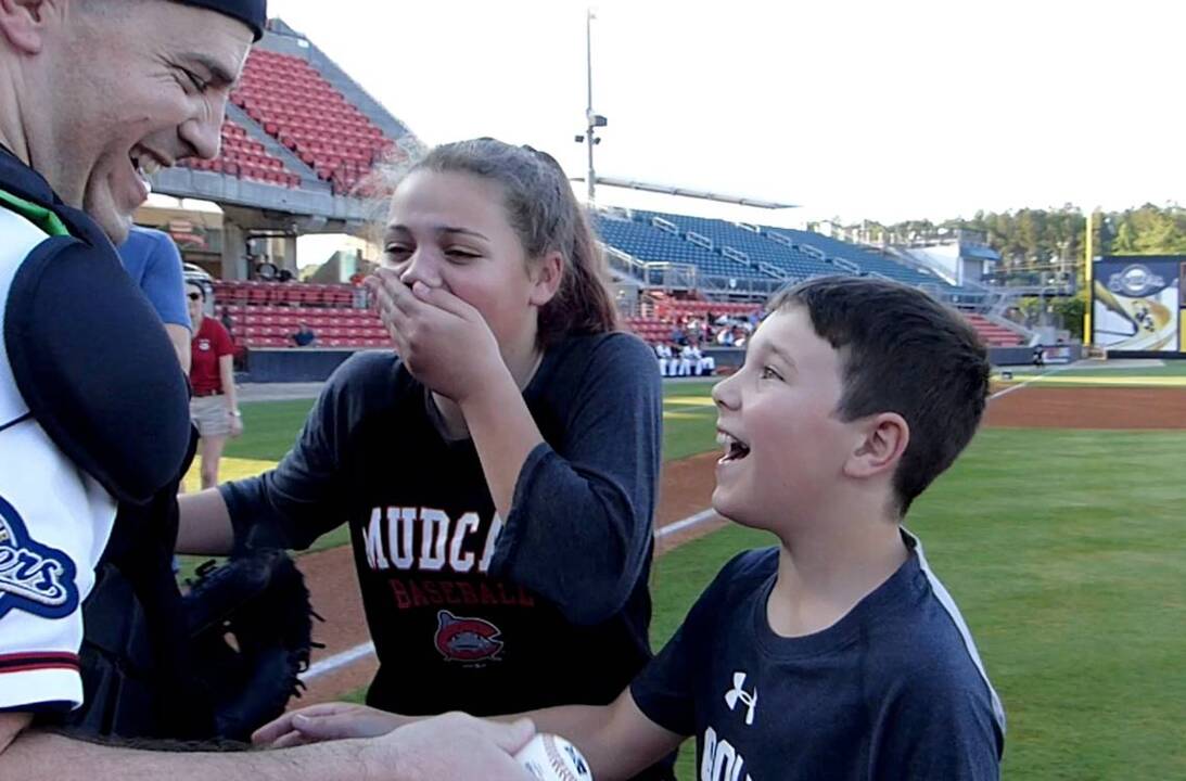 Airman surprises his kids as they throw out first pitch for Mudcats