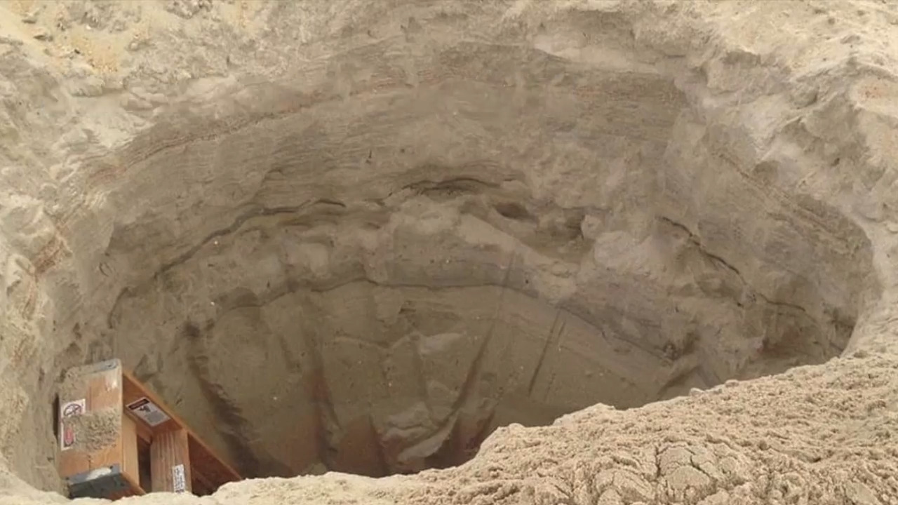 Stop digging holes on the beach