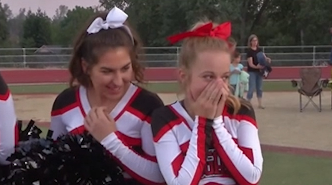 Cheerleader fighting cancer receives surprise from football team