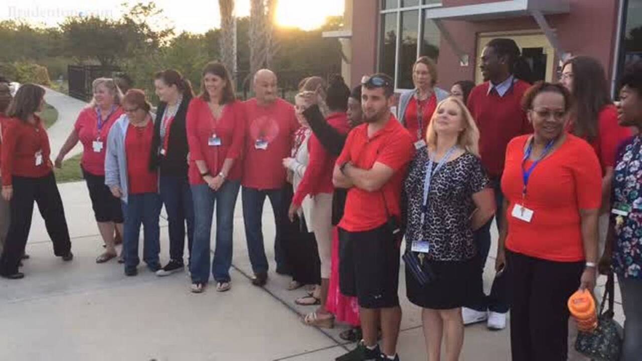 Teachers ‘walk-in’ together at schools across district