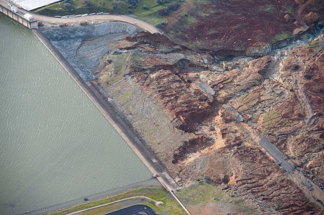Drone flies over Lake Oroville Auxiliary Spillway 