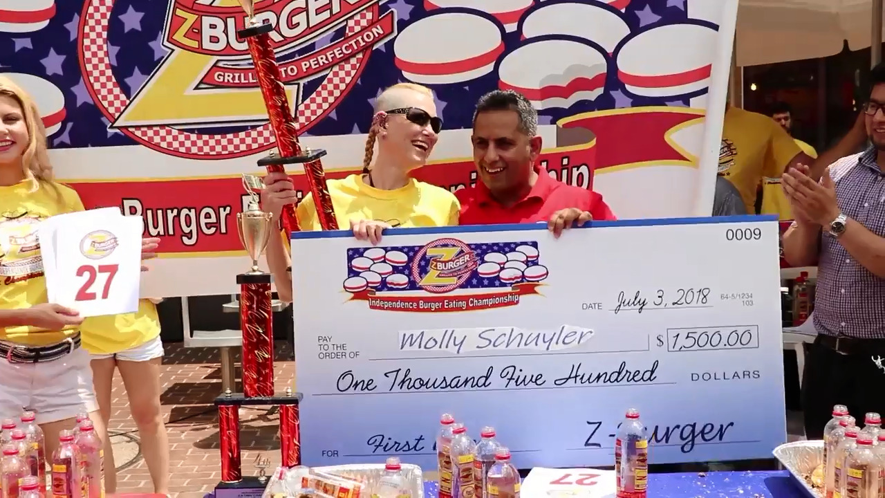 Watch competitors at the Independence Burger Eating Championship