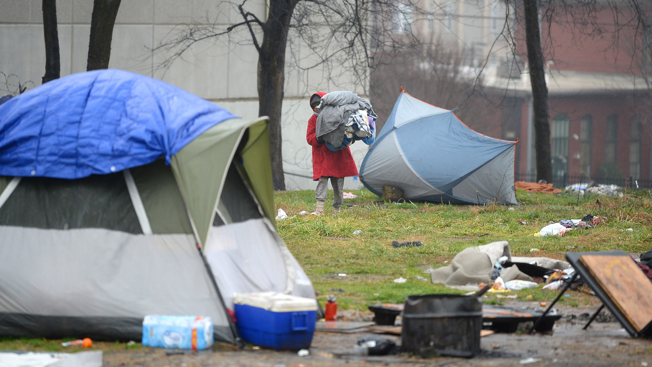 Residents of tent encampment wait in cold rain as county officials squabble