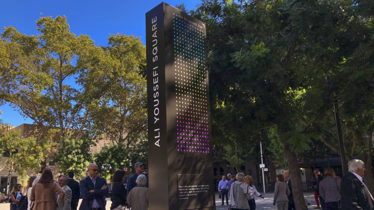Dignitaries and family help unveil the Ali Youssefi Square memorial  monument